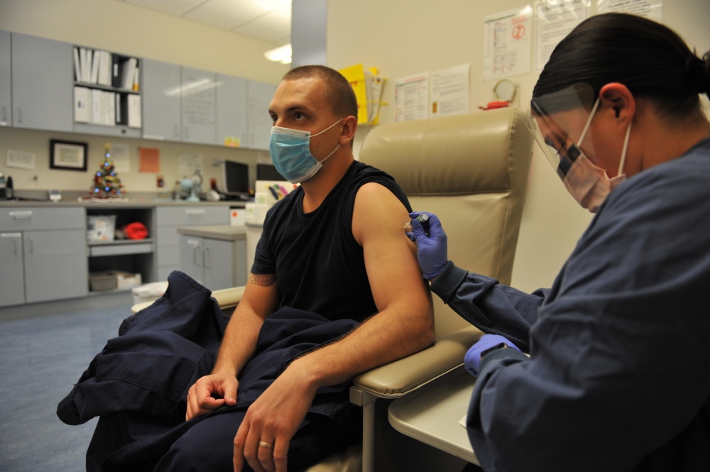 Petty Officer 3rd Class Anton Tyshyn, a yeoman stationed at U.S. Coast Guard Headquarters, receives his annual flu shot in the medical laboratory at Headquarters, Washington D.C., Dec. 1, 2020. Flu vaccination is mandatory for all Coast Guard active duty personnel to ensure mission readiness. (U.S. Coast Guard Photo by Petty Officer 2nd Class Brian McCrum)